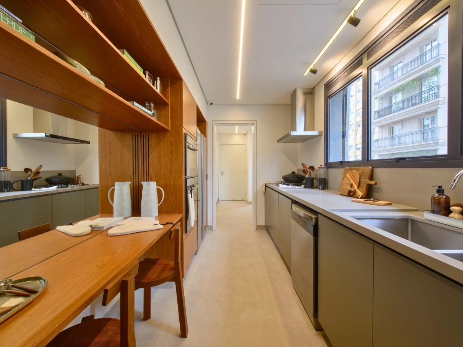 narrow-kitchen-layout-with-built-in-furniture-and-compact-dining-table-for-small-apartment