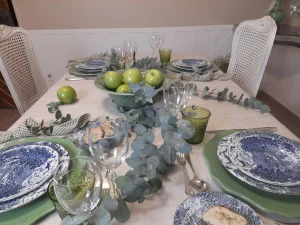 Balanced table composition ideas using silver flatware, English dinnerware, green apples and eucalyptus centerpiece