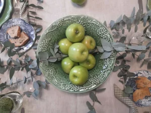 Bordallo Pinheiro centerpiece styled with green apples and fresh eucalyptus branches