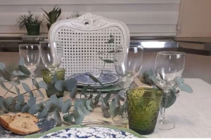 Crystal stemware styled alongside silver flatware and layered dinnerware
