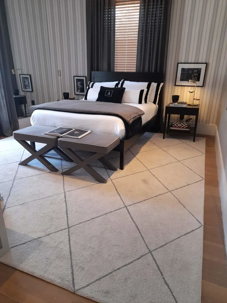 Layered bedding ideas featuring decorative pillows, a soft throw blanket and hotel-inspired styling
