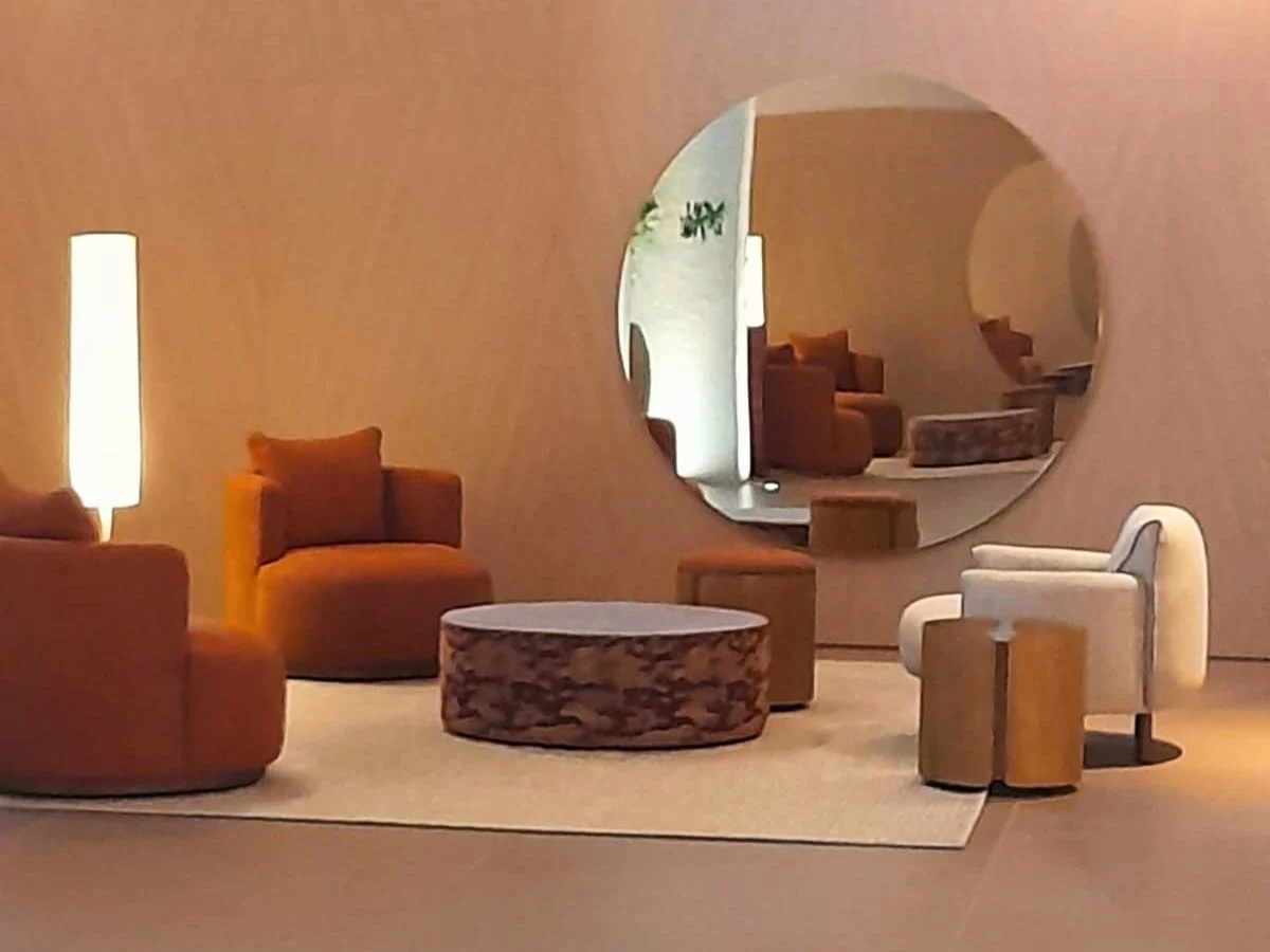 Contemporary-lobby-with-a-large-round-mirror-creating-depth-and-reflecting-natural-light