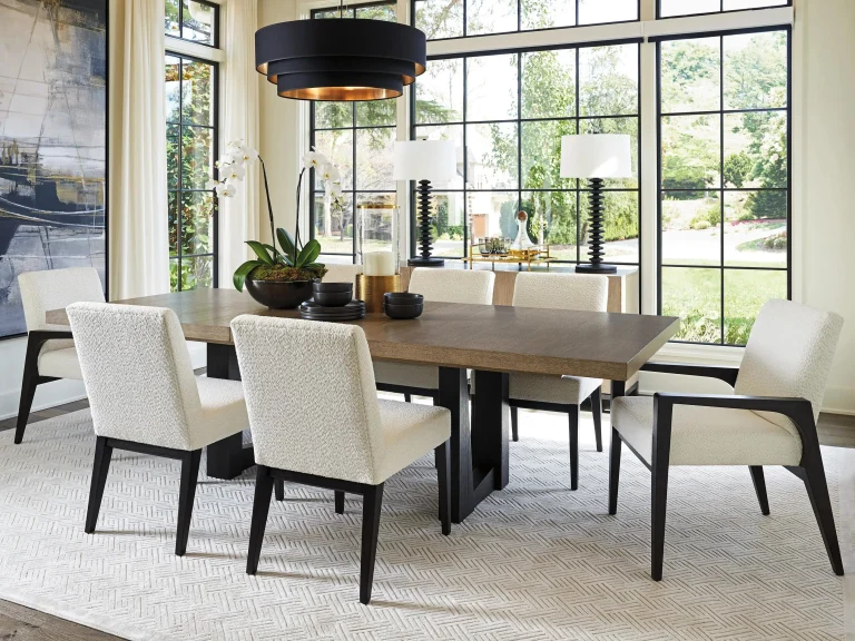 Upholstered dining chairs around a solid wood dining table in a bright, comfortable dining room with timeless interior design.
