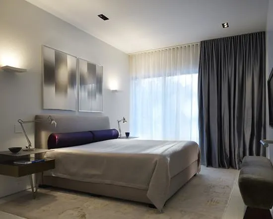 Dark-gray-bedroom-curtains-paired-with-sheer-white-curtains-in-a-modern-neutral-bedroom